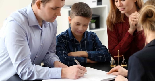 Parents looking at documents with child